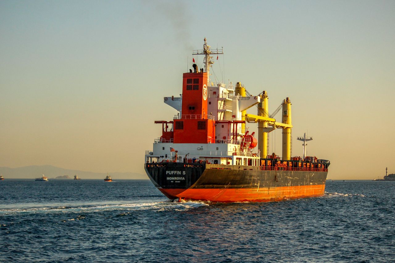 The Art of Drawing Readers In: Your attractive post title goes here A vibrant container ship navigating the Bosphorus Strait, Istanbul during sunset, enhancing the maritime scenery.