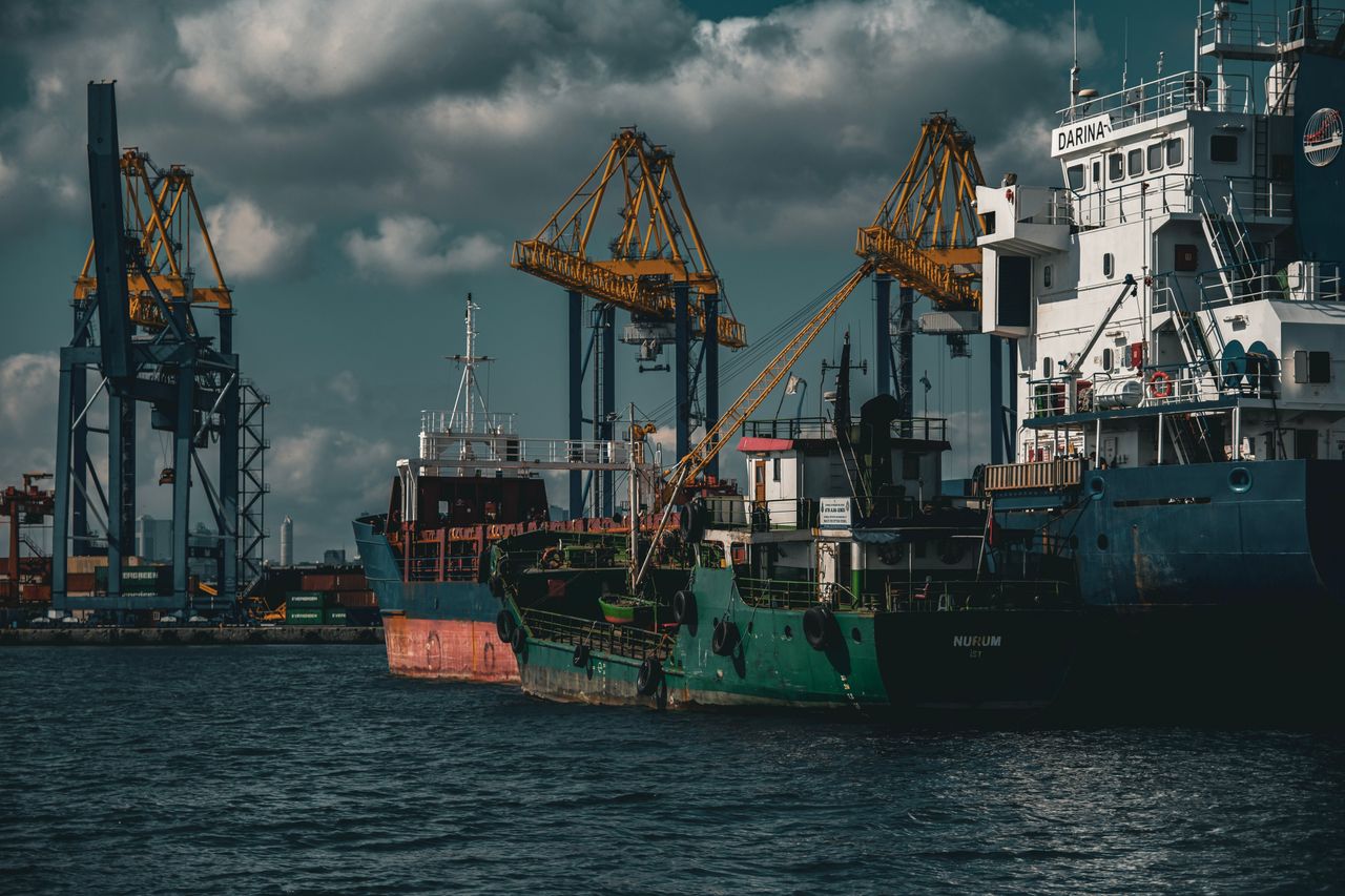 Cargo ships and cranes in an industrial port in Istanbul. Captured on a cloudy day.