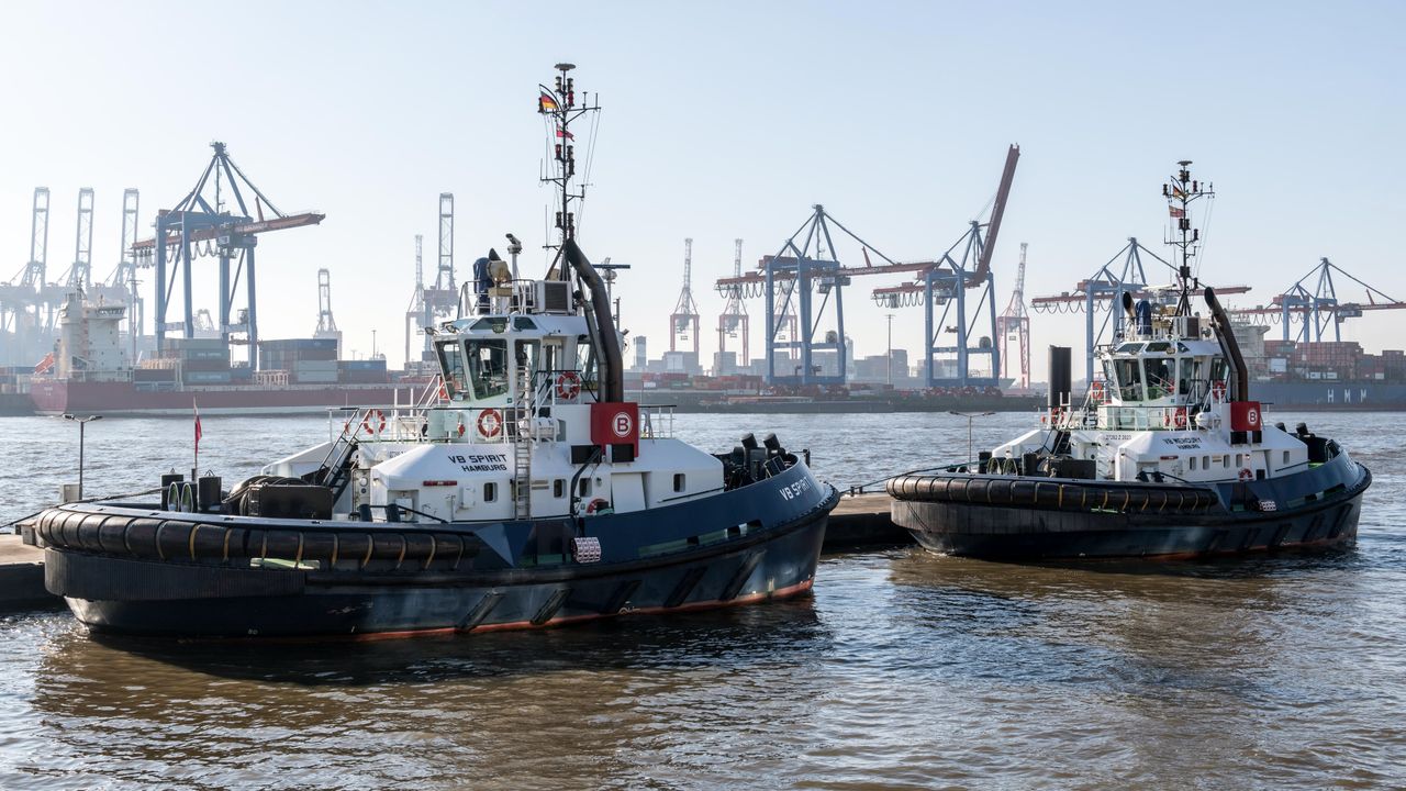 The Art of Drawing Readers In: Your attractive post title goes here Tugboats at Hamburg Harbor with cranes in the background on a sunny day.