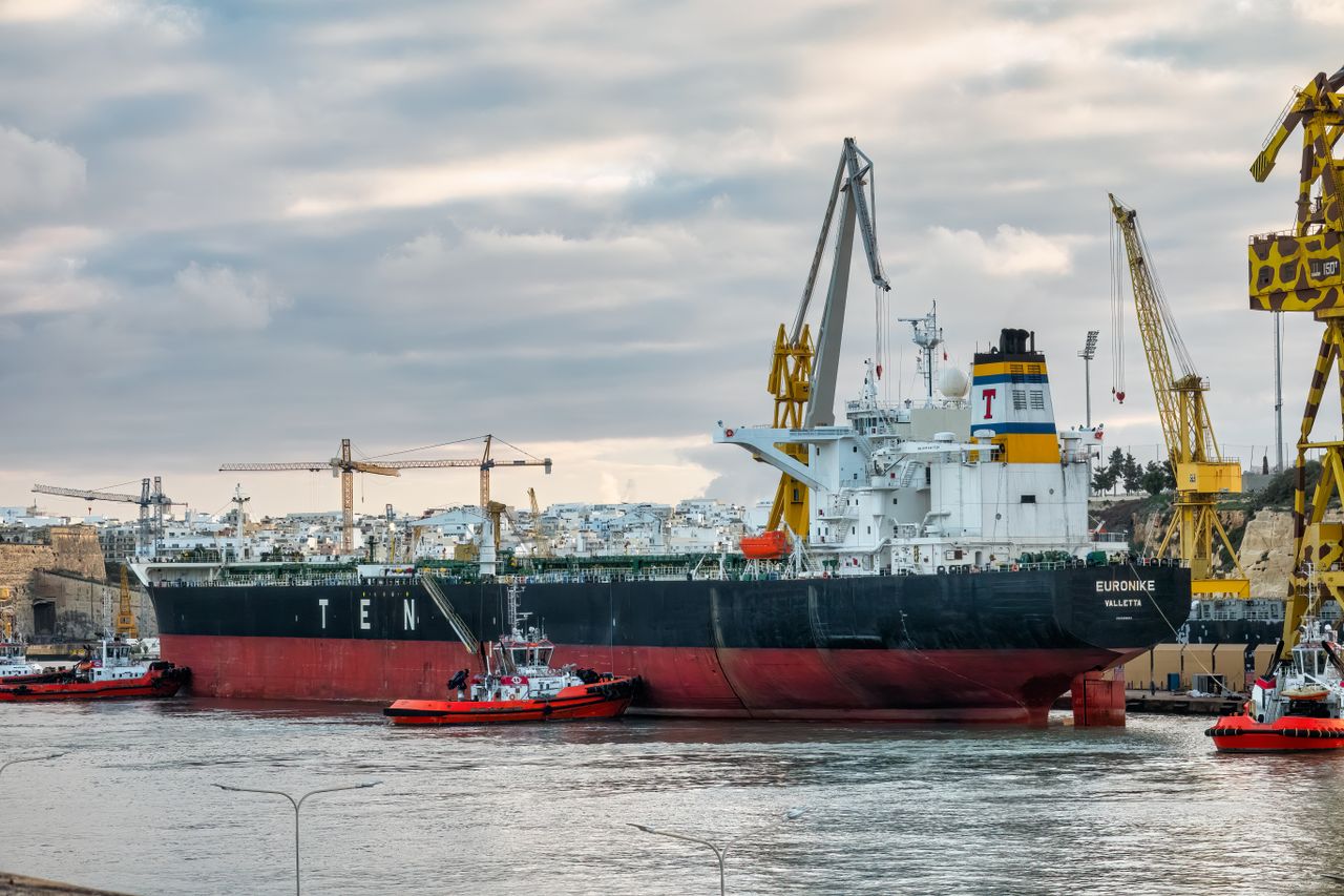 Crafting Captivating Headlines: Your awesome post title goes here Cargo ship Euronike docked in Malta with tugboats and cranes nearby.